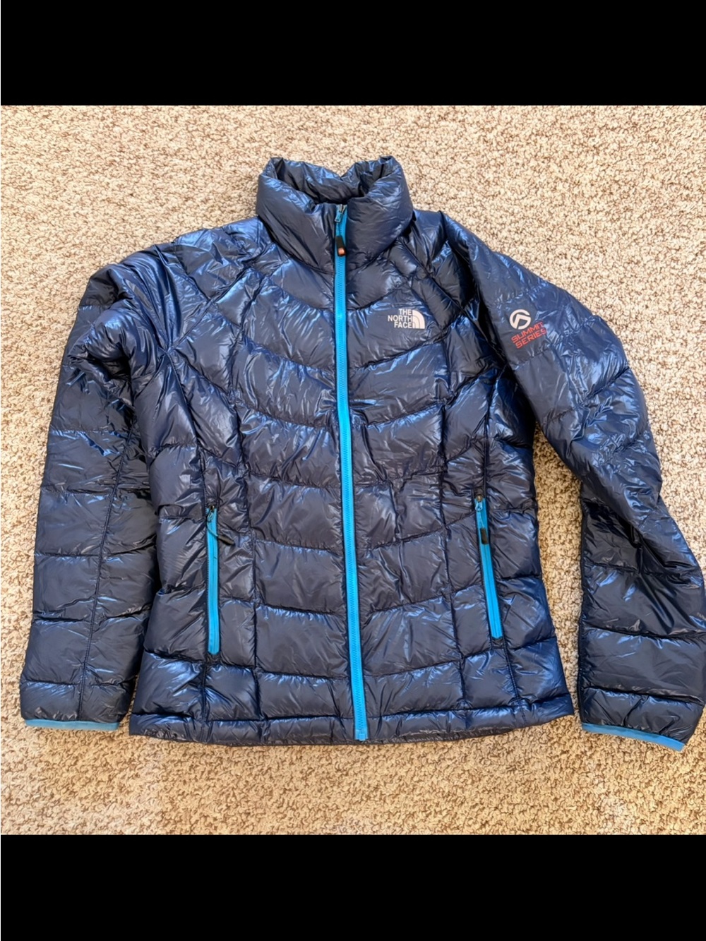 The North Face Women's Navy Blue Puffer Jacket with Teal Trim